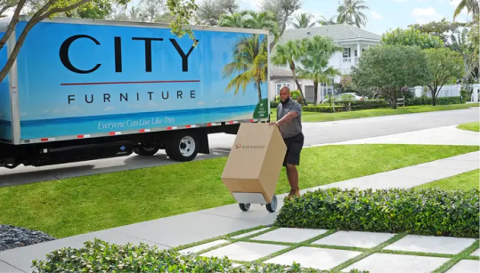 City Furniture truck and a delivery man bringing boxes
