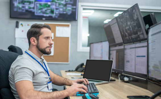 Software developer in the office with code on screens