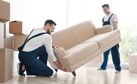 Delivery men carefully placing a couch in a nice home