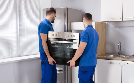 Delivery men installing an oven