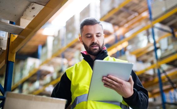 Employee in a warehouse checking a tablet